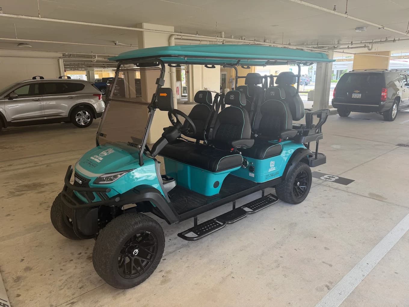 Teal 6-seater street-legal luxury golf cart from the Adventures Beach Rentals fleet